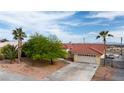 Spacious home featuring a tile roof, desert landscaping, and a long driveway leading to a two-car garage at 3481 Winery Rd, Pahrump, NV 89048