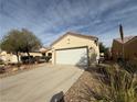 A single-story home with a two car garage and low maintenance desert landscaping at 3508 Kittiwake Rd, North Las Vegas, NV 89084