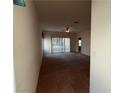 Open living room featuring carpet, tile flooring, ceiling fan, and sliding glass doors at 3508 Kittiwake Rd, North Las Vegas, NV 89084
