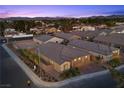 An aerial view of single-Gathering homes and landscaped street, with palm trees lining the street and community at 3706 Etendre Ct, Las Vegas, NV 89121