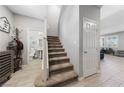 Open entryway featuring staircase, neutral walls, and easy access to a half bath at 3854 Stadium Ave, Las Vegas, NV 89120