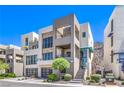 Contemporary multi-level home features a gated entrance, landscaped front yard, and modern architectural details at 414 Tranquil Peak Ct, Henderson, NV 89012