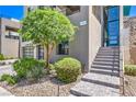 Landscaped front entrance with stone pavers, lush greenery, and a modern blue front door at 414 Tranquil Peak Ct, Henderson, NV 89012