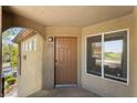 Inviting entryway featuring a paneled front door, window, and covered porch at 4400 S Jones Blvd # 2033, Las Vegas, NV 89103