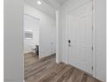 Bright entryway showcasing hardwood floors, a white front door, and an open view of the bathroom at 485 Pebble Run Ave, Henderson, NV 89011