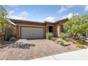 Attractive single-story home featuring a paved driveway and appealing desert landscaping at 485 Pebble Run Ave, Henderson, NV 89011