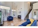 Bright living room with soaring ceilings, wood-look floors, and comfortable seating at 5502 Cinnamon Ave, Las Vegas, NV 89122