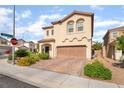 Charming two-story home with a brick driveway and well-maintained landscaping on a sunny day at 7083 Seat Wall Rd, Las Vegas, NV 89148