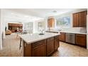 Bright open kitchen features stainless steel appliances, a large island, and tile flooring at 7466 Matilda St, Las Vegas, NV 89113