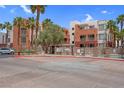 Beautiful exterior view of the community with mature palm trees at 75 E Agate Ave # 206, Las Vegas, NV 89123
