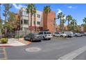 Spacious parking lot with designated parking and lush landscaping at 75 E Agate Ave # 206, Las Vegas, NV 89123