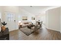 Bright living room boasts stylish furnishings, wood floors, and ample natural light at 7754 Pink Ginger St, Las Vegas, NV 89123