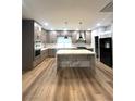 Spacious kitchen featuring a large marble island, gray cabinets, and stainless steel appliances at 8095 Carpenter Creek Ave, Las Vegas, NV 89113