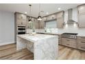 Bright kitchen with a marble island, stainless steel appliances, and shaker cabinets at 8095 Carpenter Creek Ave, Las Vegas, NV 89113