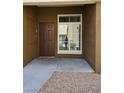 Close-up shot of front door with a small window and gravel entryway providing curb appeal at 9000 Las Vegas Blvd # 1250, Las Vegas, NV 89123