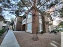 Low angle exterior view of the townhome featuring gravel landscaping and well-maintained surroundings at 9000 Las Vegas Blvd # 1250, Las Vegas, NV 89123
