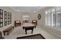 Well-lit game room featuring a pool table, neutral walls, and carpeted floors at 9046 Barium Rock Ave, Las Vegas, NV 89143