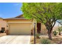 Charming single-story home featuring a two-car garage, desert landscaping, and stone accents at 9137 Big Plantation Ave, Las Vegas, NV 89143