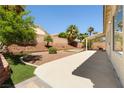 Spacious backyard featuring desert landscaping and a covered patio at 9282 W Viking Rd, Las Vegas, NV 89147
