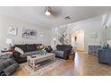 Comfortable living room with tile floors, neutral walls, cozy sofas, and a staircase in the background at 9513 Perennial View Ave, Las Vegas, NV 89148