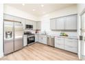 Contemporary kitchen features stainless steel appliances, gray cabinetry, sleek countertops, and ample natural light at 10301 Coal Creek Pl, Las Vegas, NV 89134