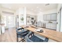 Modern kitchen with gray cabinets, stainless steel appliances, a breakfast bar, and an inviting open layout at 10301 Coal Creek Pl, Las Vegas, NV 89134