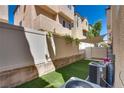 Private backyard featuring easy-care artificial grass and shade covering at 10519 Mann St, Las Vegas, NV 89141