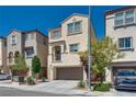 Well-maintained two-story home featuring a front-facing two car garage, with desert landscaping at 10519 Mann St, Las Vegas, NV 89141