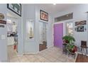 Bright entryway features tile floors, a striking purple door, and an open view to living areas at 10832 Heritage Hills Dr, Las Vegas, NV 89134