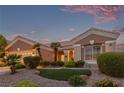 Attractive home displaying a well-maintained front yard with desert landscaping elements at 10832 Heritage Hills Dr, Las Vegas, NV 89134