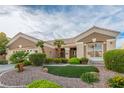Inviting single-story home featuring manicured landscaping, gravel yard, and mature palm trees at 10832 Heritage Hills Dr, Las Vegas, NV 89134