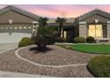 Charming home featuring low-maintenance desert landscaping and mature palm trees enhancing curb appeal at 10832 Heritage Hills Dr, Las Vegas, NV 89134