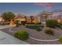 Charming single-story home featuring desert landscaping with mature trees and a well-manicured lawn at 10832 Heritage Hills Dr, Las Vegas, NV 89134