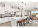 Modern kitchen with a large island, stainless steel appliances, sleek lighting, and an adjacent living space at 11280 Granite Ridge Dr # 1012, Las Vegas, NV 89135