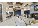 Bright living room features a modern fireplace, plush white seating and a built-in bar overlooking city views at 1228 Stellar Rim Ct, Henderson, NV 89012