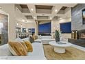 Bright, open-concept living room featuring a modern fireplace, plush white seating, and city views at night at 1228 Stellar Rim Ct, Henderson, NV 89012