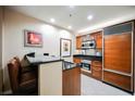 Cozy kitchen features wood cabinetry, black countertops, and modern stainless steel appliances at 135 Harmon Ave # 3220, Las Vegas, NV 89109