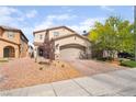 Attractive two-story home featuring desert landscaping, a two-car garage, and a welcoming entryway at 162 Sand Lake St, Henderson, NV 89074