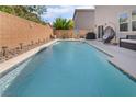 Sparkling pool surrounded by a patio, complete with outdoor furniture, provides a perfect spot for relaxation and entertainment at 162 Sand Lake St, Henderson, NV 89074