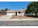 Charming single-story home featuring a well-manicured front yard and a two-car garage at 1620 Yellow Rose St, Las Vegas, NV 89108