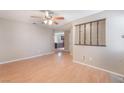 Living room with hardwood floors, open layout, ceiling fan, and lots of natural light at 1729 Yellow Rose St, Las Vegas, NV 89108