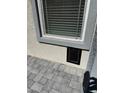 Close-up of an exterior window with a pet door installed beneath at 1906 Arietta Vista St, Henderson, NV 89044