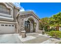 Close-up of the front door with stone accents and a well-manicured lawn at 2959 Azure Bay St, Las Vegas, NV 89117