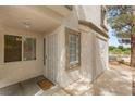 Condo entry featuring security door, twin windows, and large storage closet at 3125 N Buffalo Dr # 1103, Las Vegas, NV 89128