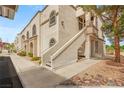 Building exterior with landscaped walkway, stairs to upper units, and desert landscaping at 3125 N Buffalo Dr # 1103, Las Vegas, NV 89128