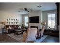 Comfortable living room with a modern fireplace and ample natural light from multiple windows at 32 Via Del Fiume, Henderson, NV 89011