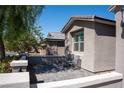 Cozy outdoor patio area with stone pavers, perfect for relaxing or entertaining guests in style at 32 Via Del Fiume, Henderson, NV 89011
