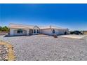 Attractive single-story home featuring a tile roof, desert landscaping and a circular paved driveway at 3581 Margarita Ave, Pahrump, NV 89048