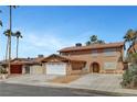 Inviting two-story home with a wide driveway, showcasing ample parking and a welcoming facade at 4990 Spring Oak St, Las Vegas, NV 89120