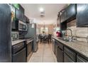 Cozy kitchen with tile floors and stainless steel appliances at 5804 Apple Valley Ln, Las Vegas, NV 89108